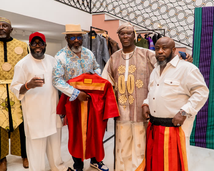 Patrons with a crimson agbada at the showcase
